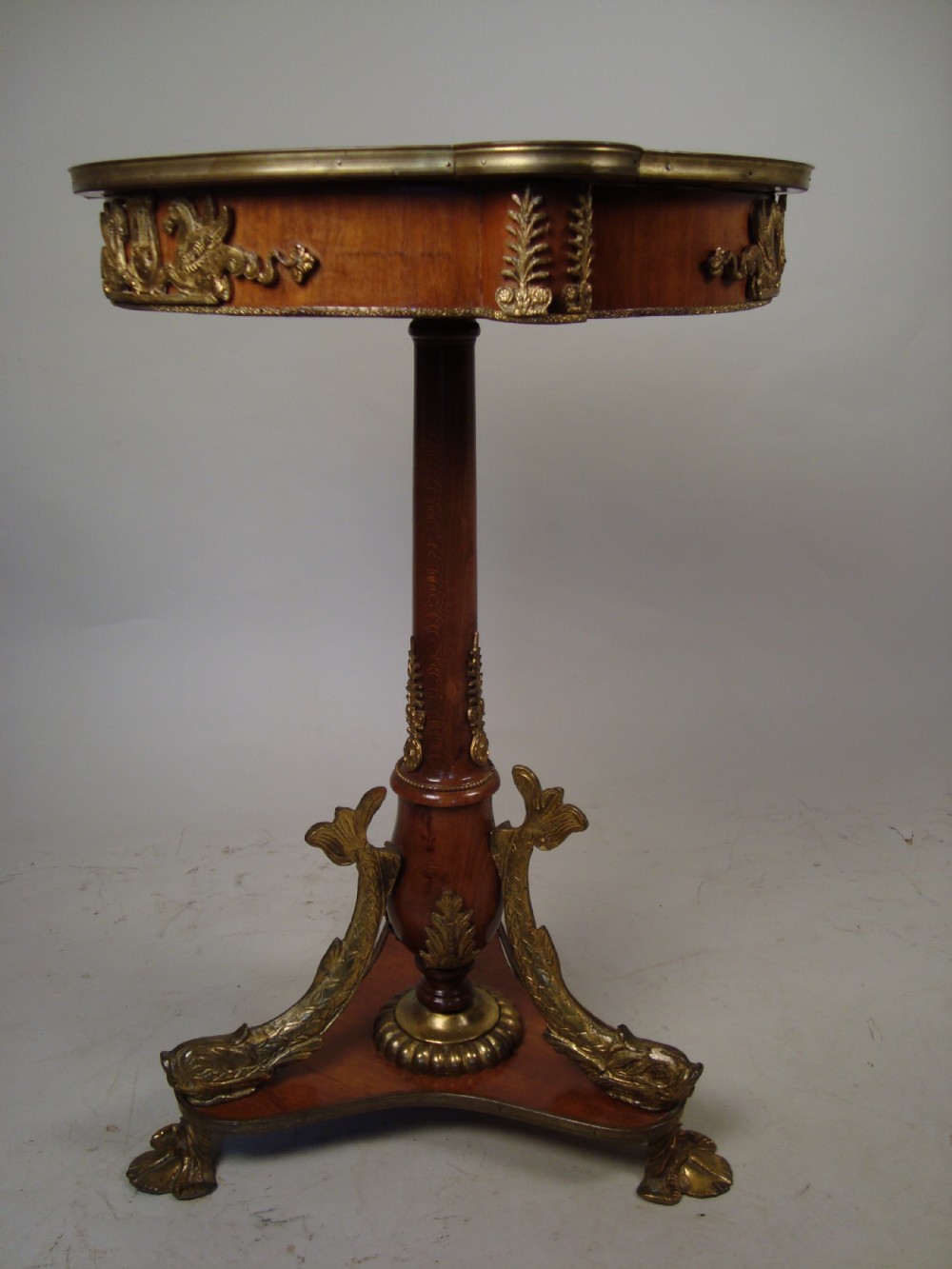 a stunning walnut and brass mounted occasional table