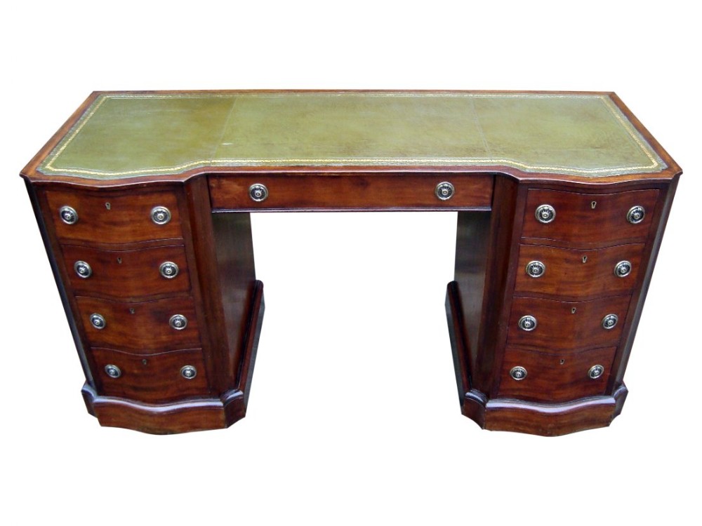 an impressive victorian serpentine front pedestal writing desk