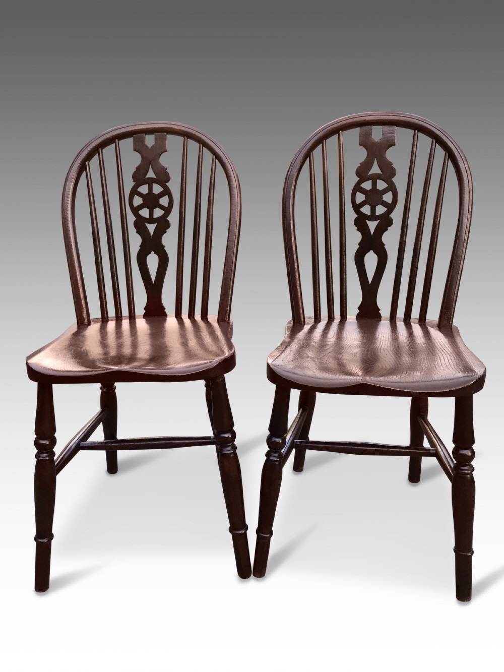 a pair of late georgian wheel back windsor kitchen chairs in oak elm